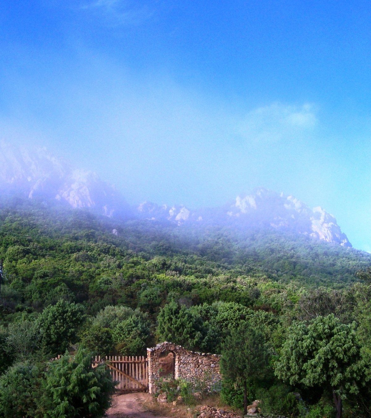 Entrance gate, mediterranean scrub and granite rocks - Cala Jami Inayati Sufi center